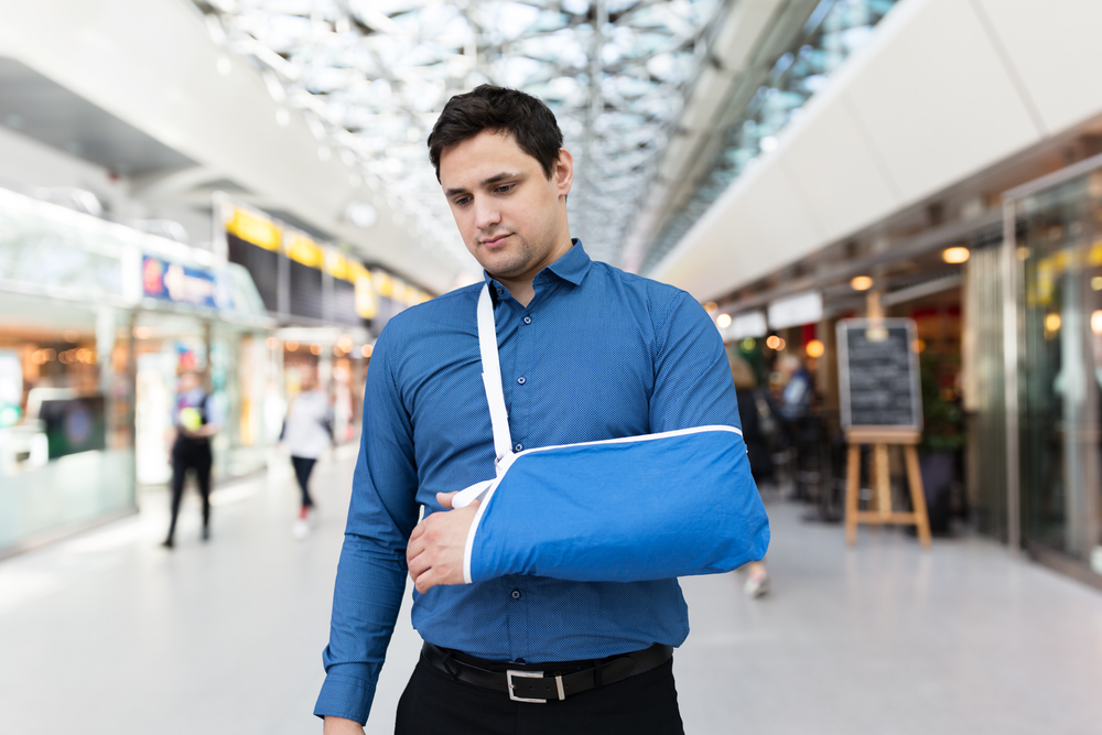 Man With Broken Arm In Airport Terminal